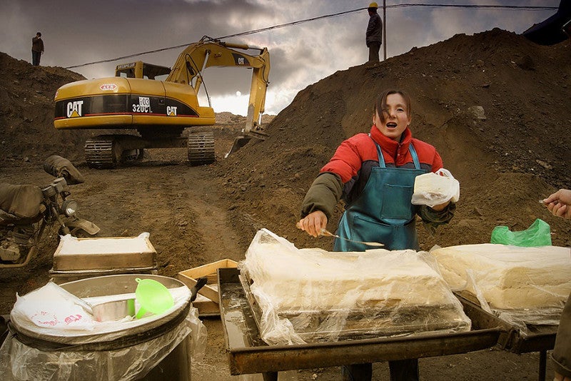 A woman works at her small tofu shop