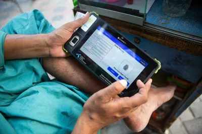A Pakistani man on his smartphone sending a money transfer