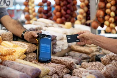 a credit card reading machine being used at a street market 